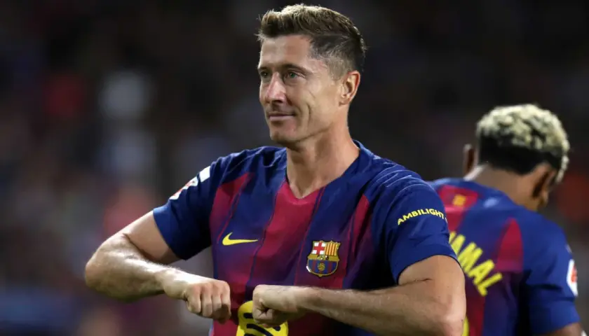 Robert Lewandowski w koszulce FC Barcelony, świętuje bramkę. To właśnie w tym klubie gra Lewandowski.