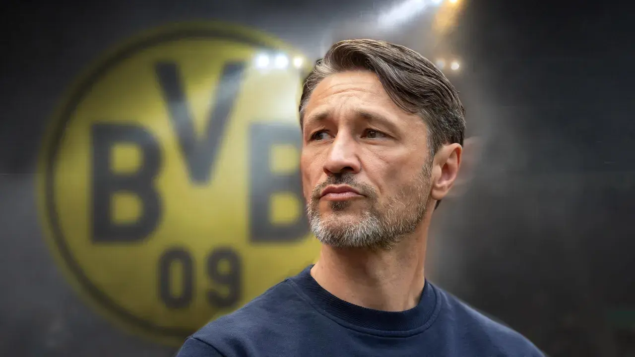 Twarz trenera Borussii Dortmund, z charakterystycznym logo klubu w tle.