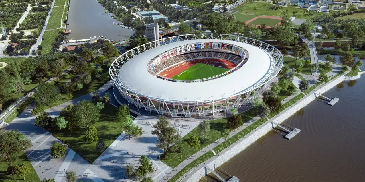 Nowoczesny stadion w Budapeszcie, otoczony zielenią i wodą, z bieżnią i murawą.